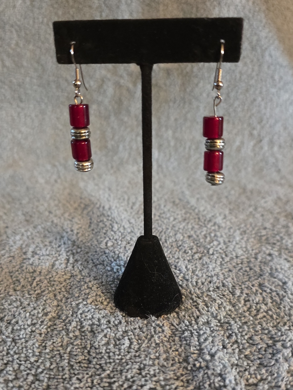 dangle earrings feature stacked red cylindrical beads separated by silver-tone